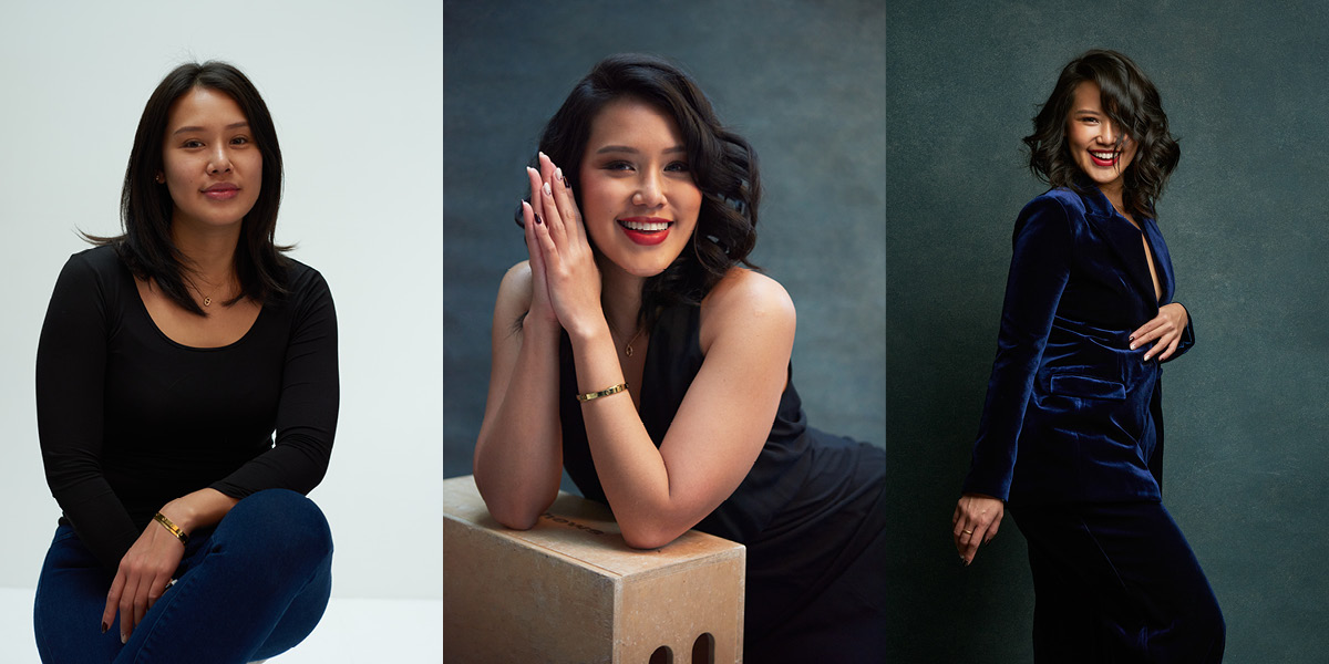 two women posing for a picture and one is sitting on a box