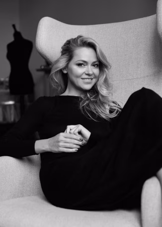 a woman sitting in a chair with a cup of coffee