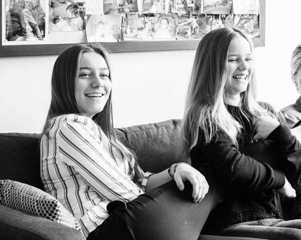 three women sitting on a couch smiling