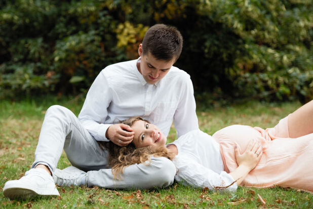 a man and woman laying on the grass