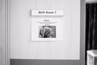 a bathroom with a sign on the wall