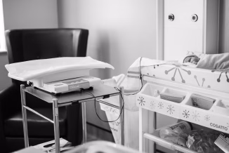 a baby in a crib in a room