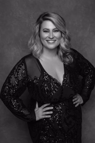 a woman in a black dress posing for a picture