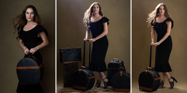 a woman in a black dress with a suitcase